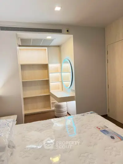 Modern bedroom with stylish built-in vanity and plush mattress, perfect for a cozy and elegant living space.