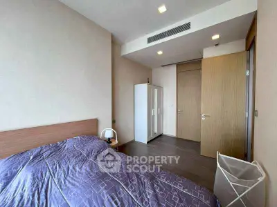 Modern bedroom with stylish decor and ample natural light