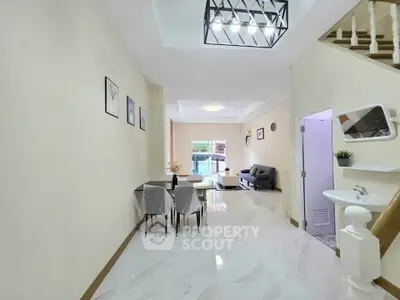 Spacious open-plan living and dining area with modern decor and natural light.