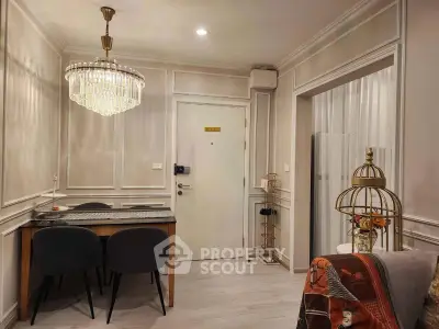 Elegant living room with chandelier and modern decor in a stylish apartment.
