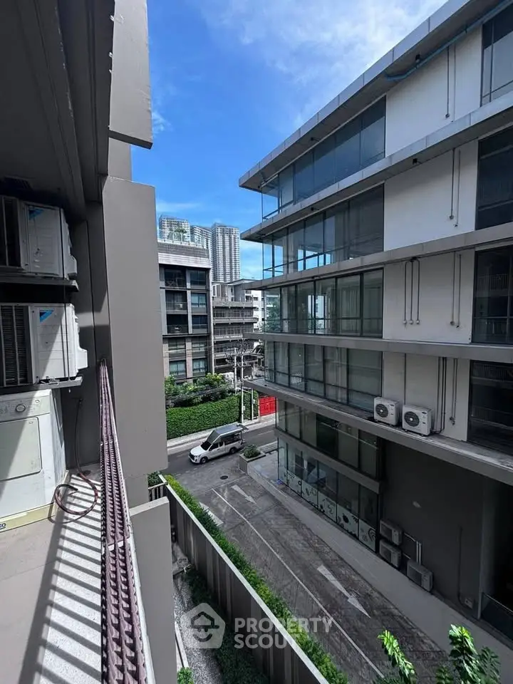 Modern urban apartment buildings with sleek design and large windows, showcasing a vibrant city view.