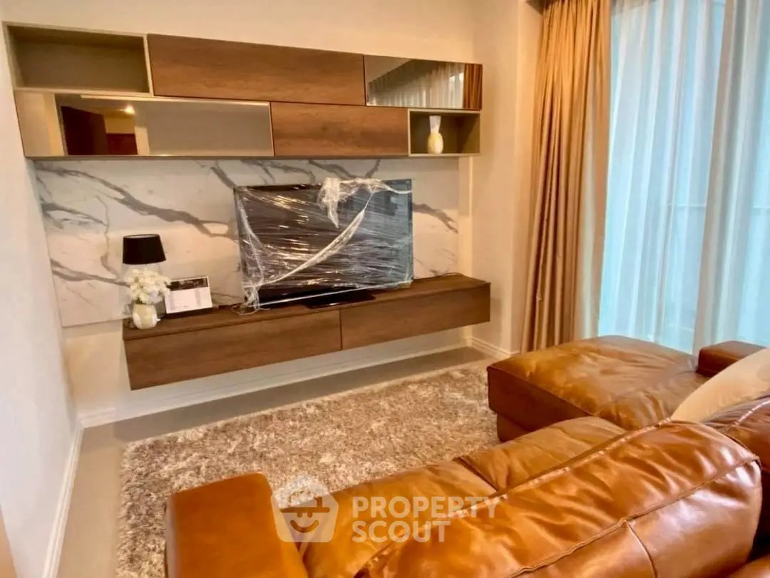 Luxurious living room with leather sofa and modern TV setup