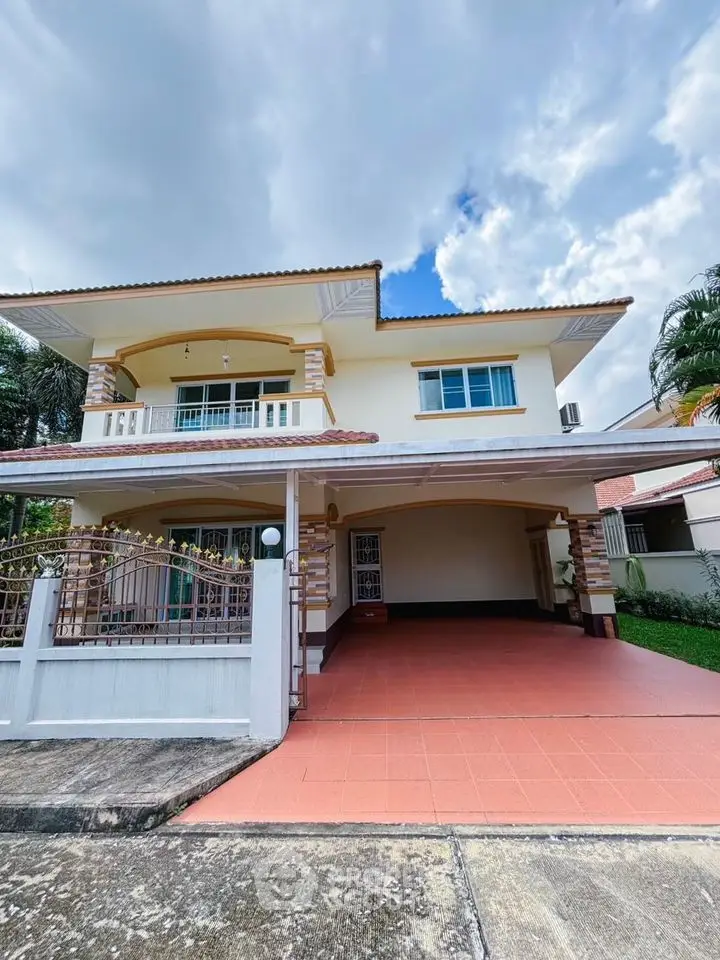 Spacious two-story house with large driveway and elegant exterior design.