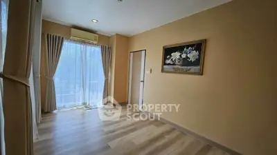 Spacious empty room with elegant curtains and wooden flooring, perfect for customization.