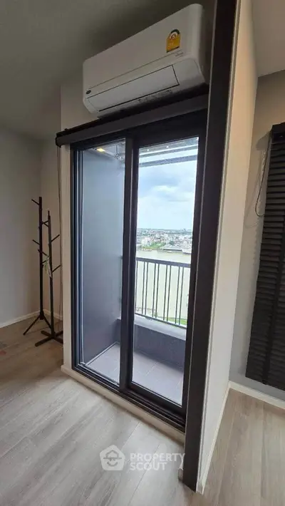 Modern apartment with balcony and air conditioning, offering a stunning city view.