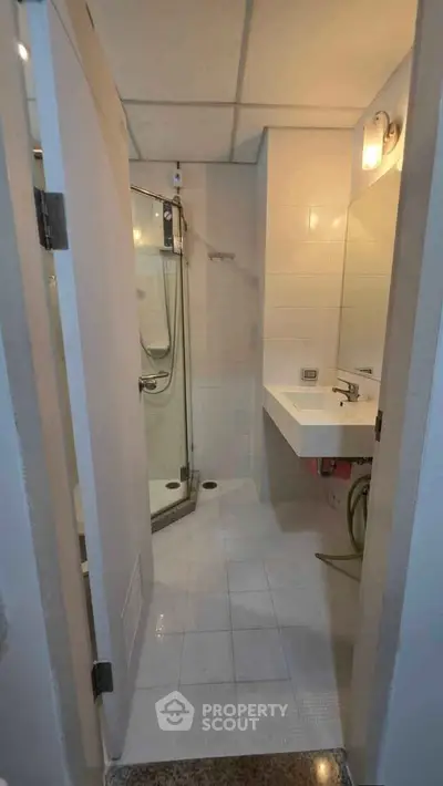 Compact bathroom with modern shower and sleek sink design