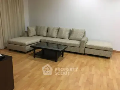 Spacious living room with elegant L-shaped sofa and wooden flooring