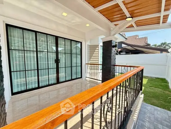 Charming balcony with elegant railing and wooden ceiling in a modern home exterior.