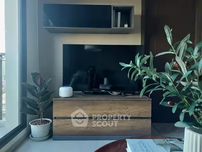 Modern living room with sleek TV setup and stylish indoor plants