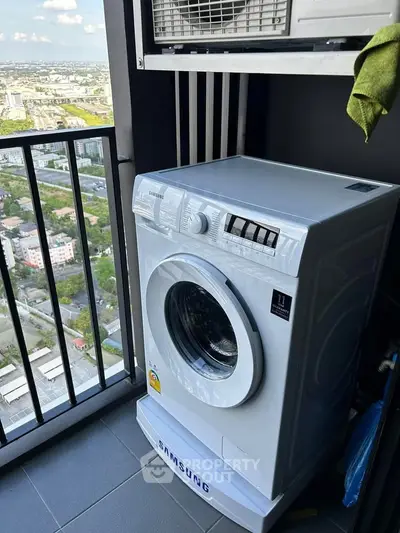 Modern washing machine on high-rise balcony with stunning city view