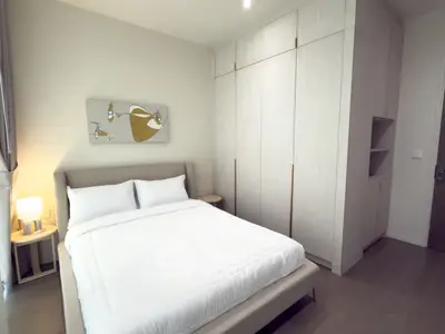 Modern bedroom with stylish decor and ample storage space