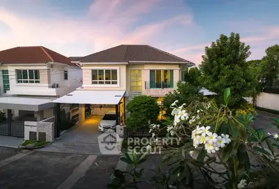 Charming suburban house with lush garden and carport at sunset, perfect family home.