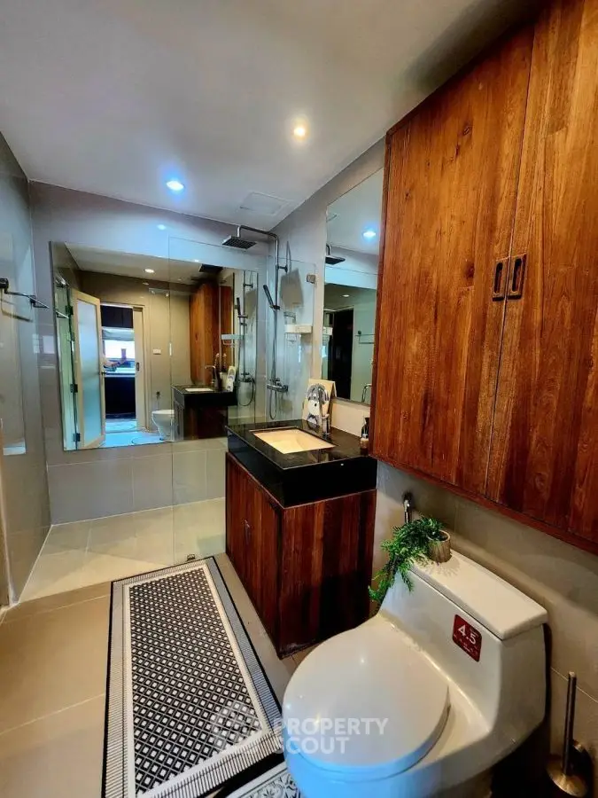 Modern bathroom with wooden cabinets and sleek fixtures