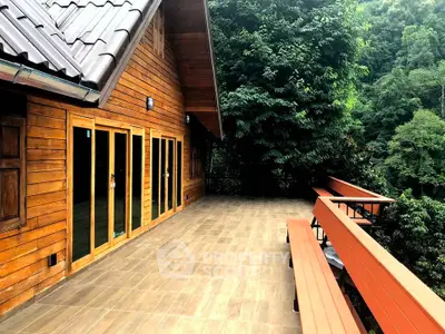 Stunning wooden cabin with expansive balcony overlooking lush greenery