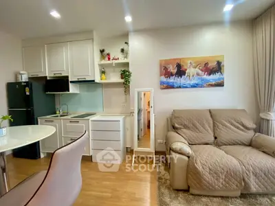 Modern living room with cozy sofa and stylish kitchen in open layout apartment.
