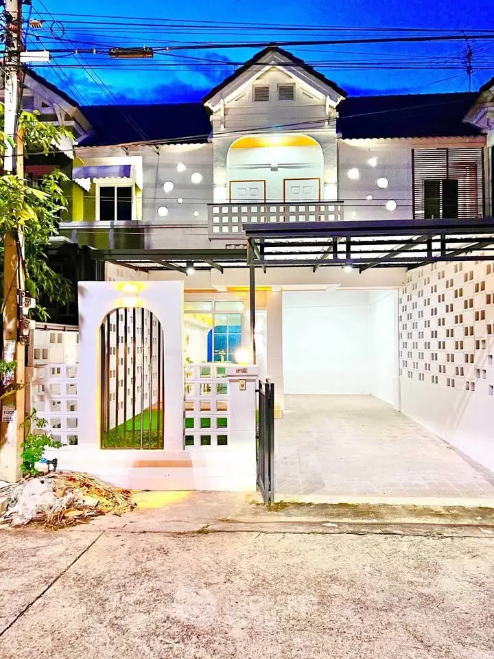 Charming two-story house with modern facade and spacious driveway at dusk.