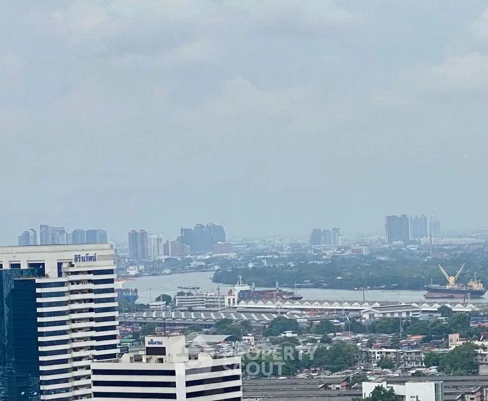 Stunning cityscape view with high-rise buildings and river, perfect for urban living enthusiasts.