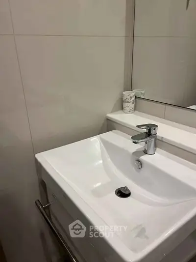 Modern bathroom with sleek white sink and stylish faucet