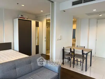 Modern studio apartment with cozy living area and dining space