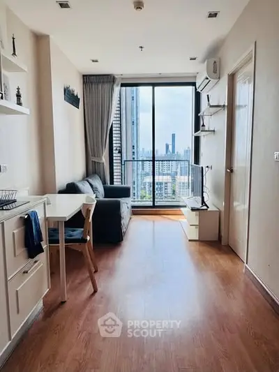 Modern living room with city view, wooden flooring, and stylish furniture in a high-rise apartment.