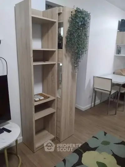 Modern living room with stylish wooden shelving and dining area
