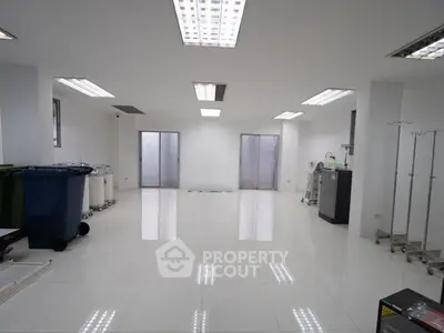 Spacious modern interior with white flooring and sleek lighting, ideal for versatile use.