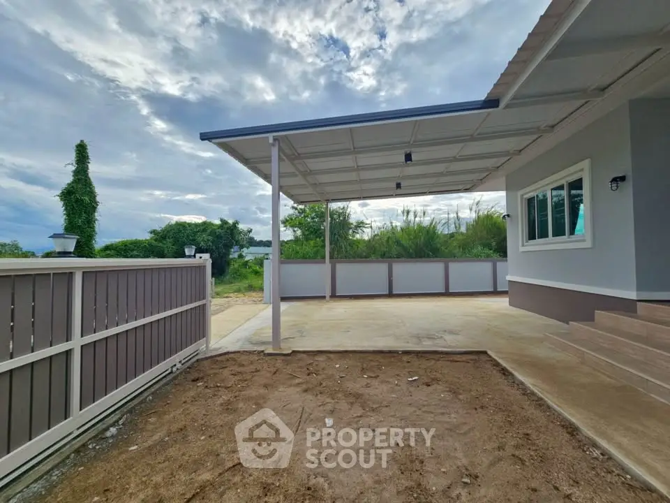 Modern house exterior with covered patio and spacious yard