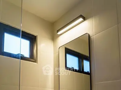 Modern bathroom with sleek lighting and small windows