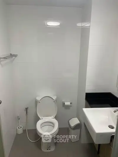 Modern bathroom with sleek white fixtures and minimalist design.
