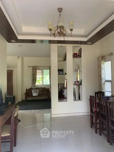 Spacious living room with elegant chandelier and natural light