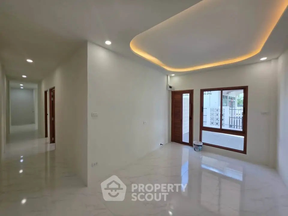 Spacious modern living room with elegant lighting and marble flooring