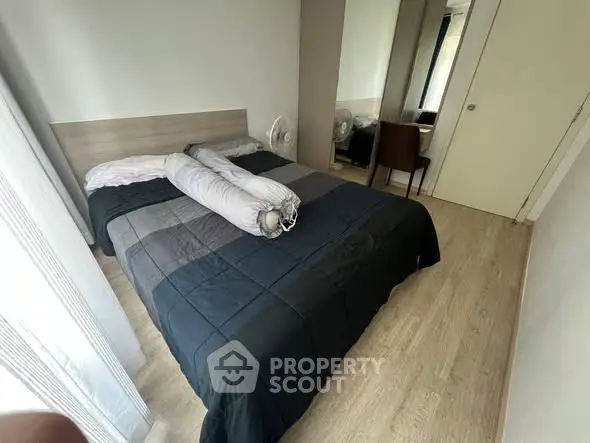 Cozy bedroom with modern decor and natural light, featuring a comfortable bed and stylish furnishings.