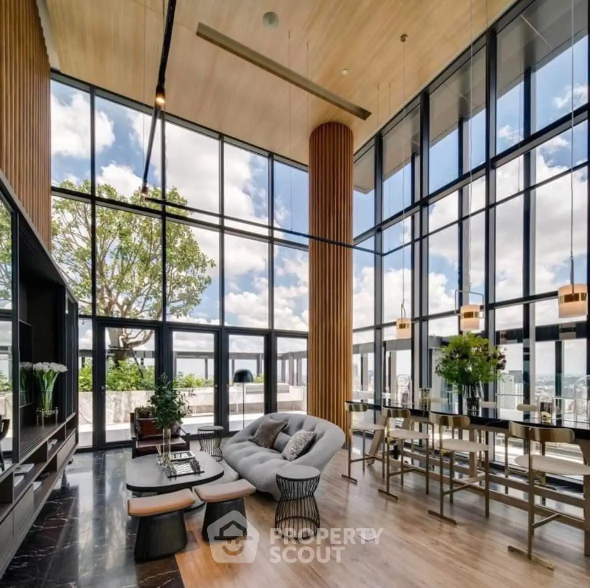 Luxurious modern living room with floor-to-ceiling windows and stunning city views.