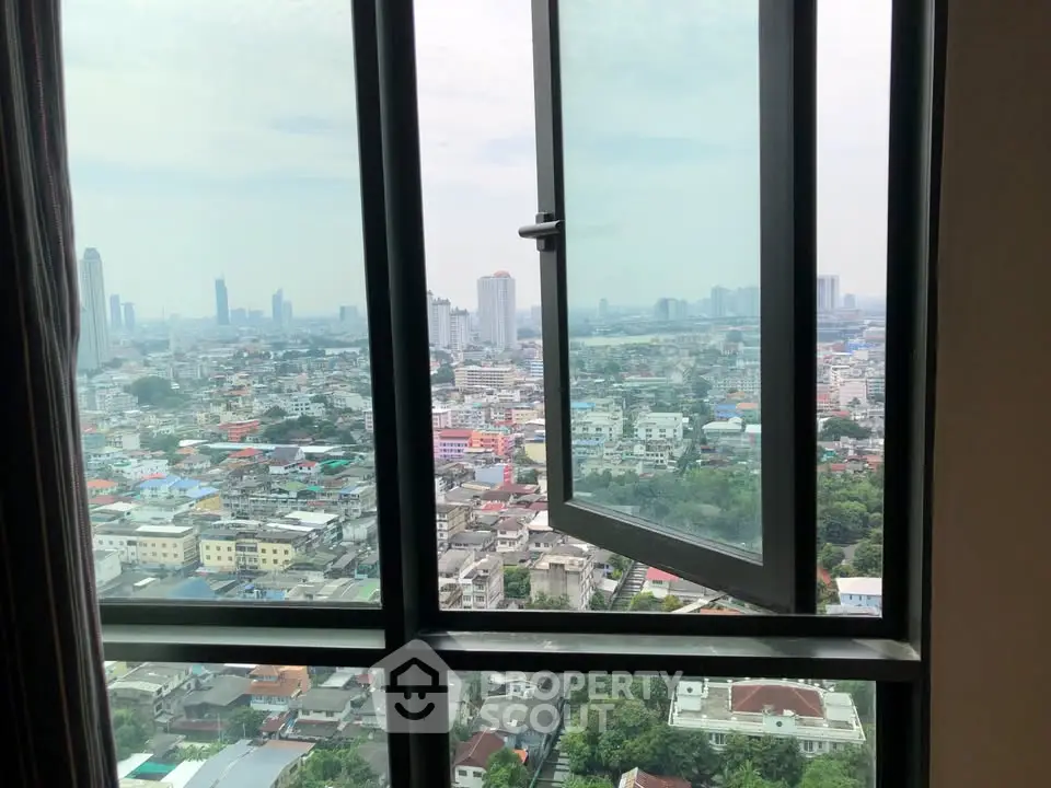 Stunning cityscape view from high-rise apartment window, showcasing vibrant urban landscape.