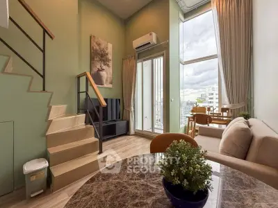 Modern duplex living room with high ceilings and balcony view