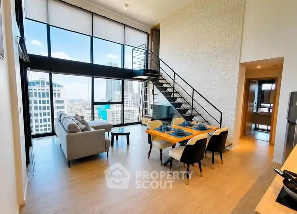 Stunning loft apartment with floor-to-ceiling windows and city views, featuring a modern open-plan living area.