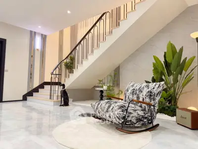 Luxurious modern living room with stylish staircase and elegant decor