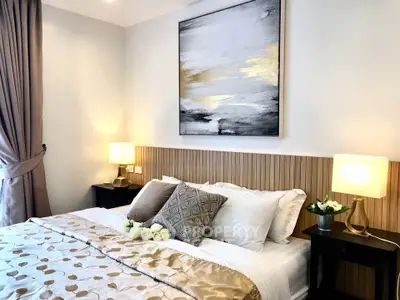 Luxurious bedroom with elegant decor and modern artwork, perfect for relaxation.
