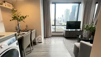 Modern living room with city view, featuring stylish decor and in-unit washer.
