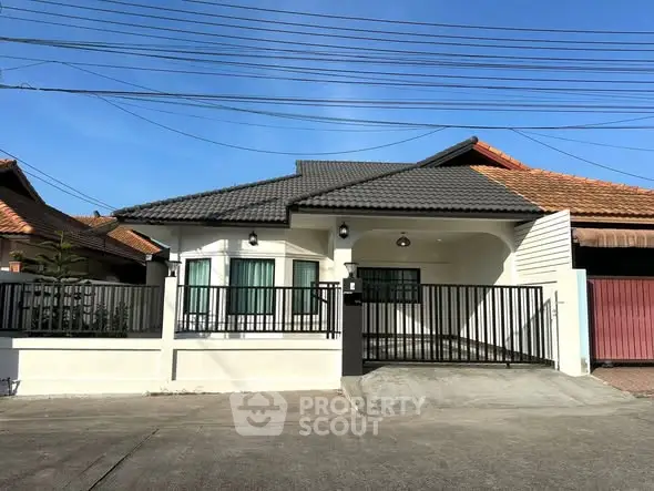 Charming single-story house with modern design and gated driveway in a serene neighborhood.