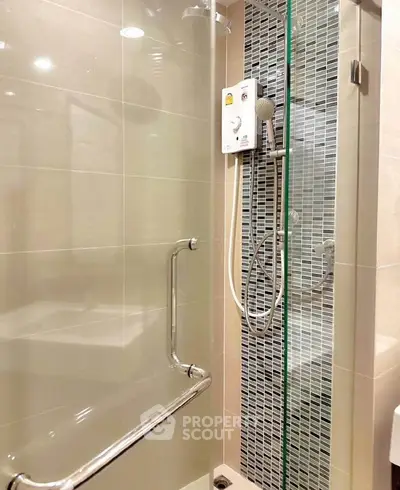 Modern bathroom with sleek shower and glass door in contemporary apartment.