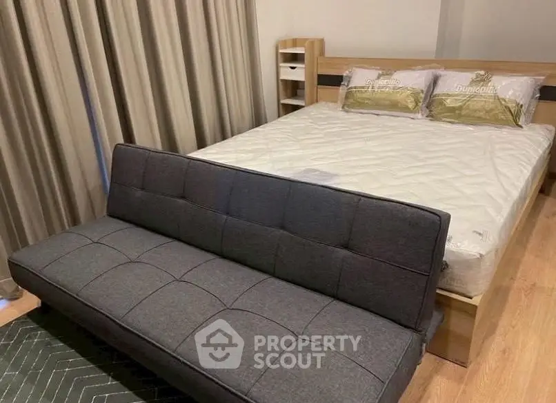 Cozy bedroom with modern sofa and stylish decor, perfect for relaxation and comfort.