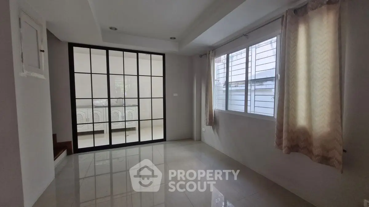 Spacious room with large windows and modern glass partition