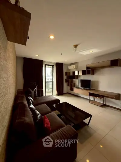 Spacious living room with modern furniture and large windows offering natural light.