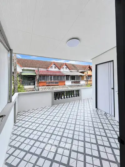Spacious balcony with tiled flooring and scenic neighborhood view, perfect for relaxation and outdoor enjoyment.