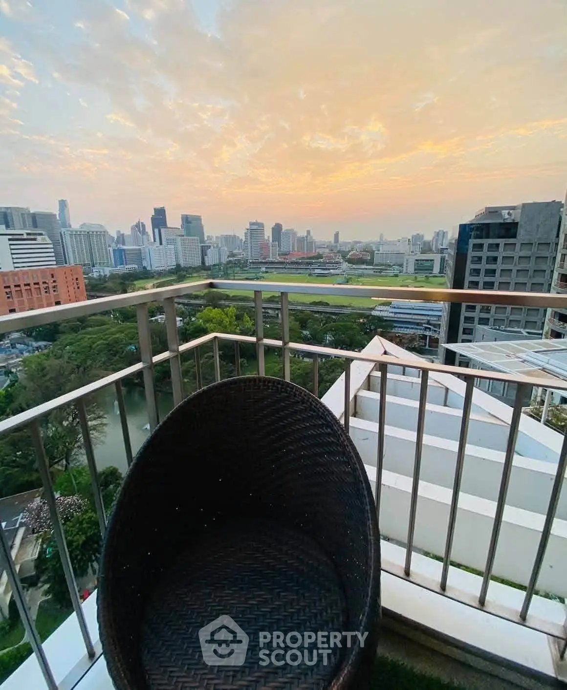 Stunning cityscape view from a high-rise balcony at sunset, perfect for urban living enthusiasts.