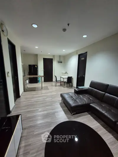 Spacious modern living room with sleek leather sofa and stylish decor