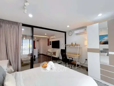 Modern studio apartment with open layout, featuring a cozy bedroom and stylish living area.