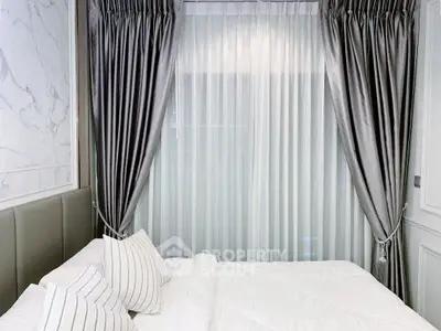 Luxurious bedroom with elegant curtains and plush bedding for a serene retreat.