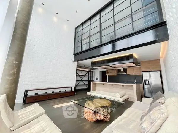 Stunning modern loft with high ceilings and sleek kitchen design, perfect for urban living.